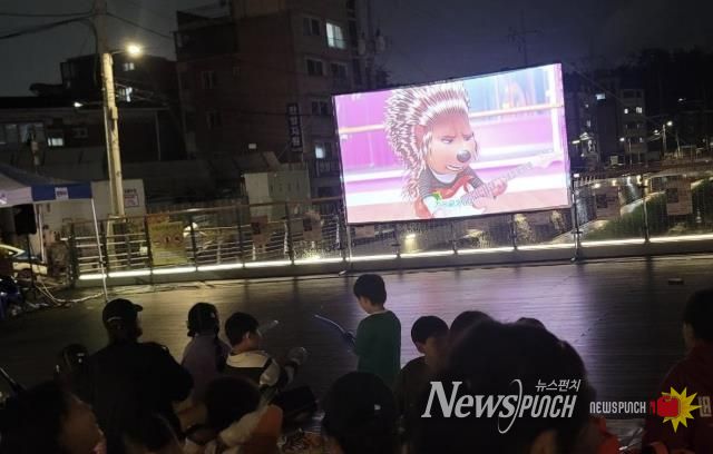 도봉1동 주민들이 누원교 마을마당에서 영화를 보고 있다.